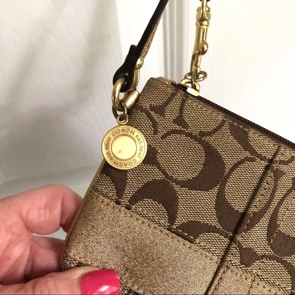 Coach signature tan wristlet, gold strap & stripe
